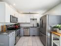 Modern kitchen with stainless steel appliances, granite countertops, and stylish two-tone cabinetry at 7605 Copper Mine Ln, Raleigh, NC 27615