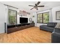 Bright living room with hardwood floors, a ceiling fan, and plenty of space for entertaining guests at 7605 Copper Mine Ln, Raleigh, NC 27615