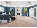 Spacious main bedroom features a fireplace, two windows, ceiling fans, and closet with mirrored doors at 7605 Copper Mine Ln, Raleigh, NC 27615