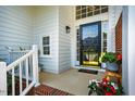 Inviting home entrance with decorative glass door and potted flowers for curb appeal at 9 Lake Village Dr, Durham, NC 27713