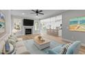 Spacious living room with a fireplace, neutral walls, and open to the kitchen and dining area at 100 Carol Cir # 17, Louisburg, NC 27549