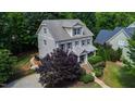 Charming two-story home with beautifully landscaped yard and a welcoming front porch at 101 Eden Glen Dr, Holly Springs, NC 27540