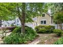 Beautifully landscaped front yard featuring mature trees, shrubbery, and walkway to front door at 102 Legacy Ln, Durham, NC 27713