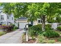 Welcoming home exterior with verdant landscaping, driveway, and charming curb appeal at 102 Legacy Ln, Durham, NC 27713