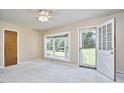 Bright living room with large windows and neutral carpet flooring at 1105 Horseshoe Rd, Durham, NC 27703