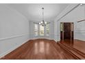 Elegant dining room with hardwood floors and a large bay window at 11425 Horsemans Trl, Raleigh, NC 27613