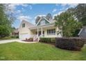 A beautiful two-story house with a well-manicured lawn, landscaping, and a large driveway at 1208 Dunn Creek Xing, Wake Forest, NC 27587