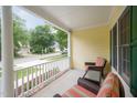 Inviting covered front porch with comfortable seating and a view of the quiet neighborhood street at 1208 Dunn Creek Xing, Wake Forest, NC 27587