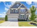 Beautiful home with a stone and siding exterior, a well-manicured lawn, and an attached two-car garage at 123 Gunderson Ln, Garner, NC 27529