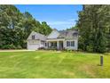 Beautifully landscaped front yard leading up to a charming single-Gathering home with a welcoming porch at 123 Holiday Island Dr, Garner, NC 27529