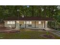 Charming single-story home with a cozy front porch and landscaped yard, nestled in a serene, wooded setting at 1302 Buffaloe Rd, Garner, NC 27529