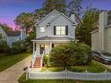 Charming two-story home features a well-maintained lawn and inviting front porch at 131 Cricketgrass Dr, Cary, NC 27513