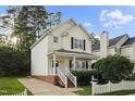 Beautiful two-story home with inviting front porch and manicured lawn at 131 Cricketgrass Dr, Cary, NC 27513