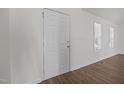 Bright entryway featuring a white door, wood flooring, and natural light from a nearby window at 148 Danesway Dr, Holly Springs, NC 27540
