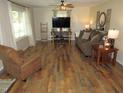 Spacious living room with hardwood floors, ceiling fan, and plenty of natural light at 1700 Warrenton Rd, Henderson, NC 27537