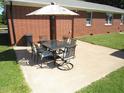 Outdoor patio with a dining set and umbrella, perfect for enjoying meals outside at 1700 Warrenton Rd, Henderson, NC 27537