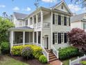Beautiful two-story home featuring a spacious front porch, balcony, and well-maintained landscaping at 1711 Happiness Hill Ln, Raleigh, NC 27614
