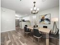 Well-lit dining area featuring modern lighting, stylish chairs, and hardwood flooring at 1911 Falls Landing Dr # 106, Raleigh, NC 27614