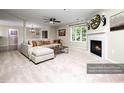 Bright living room showcasing neutral tones, a cozy fireplace, and a comfortable couch at 1911 Falls Landing Dr # 106, Raleigh, NC 27614