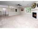 Bright living room showcasing neutral tones, a cozy fireplace, and a ceiling fan at 1911 Falls Landing Dr # 106, Raleigh, NC 27614