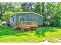 The back of the house features a wooden deck and a spacious grassy area at 230 Parkland Rd, Raleigh, NC 27603
