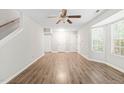 Spacious living room with wood flooring, multiple entry doors, and a window for natural light at 2309 Hoot Owl Ct, Raleigh, NC 27603