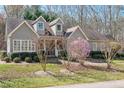 Beautiful one-story home with dormer windows, mature trees, and manicured landscaping at 2412 Mollynick Lane Ln, Wake Forest, NC 27587