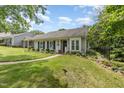 Charming home with landscaped front yard featuring colorful flower beds, a welcoming walkway, and lovely curb appeal at 2617 Cottage Cir, Raleigh, NC 27613