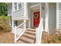 Close-up view of a home's entrance with a red door and brick steps at 3008 Isabella Dr, Raleigh, NC 27603