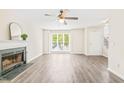 Spacious living room with large windows, fireplace, and modern flooring at 3008 Isabella Dr, Raleigh, NC 27603