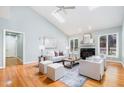 Bright living room featuring a vaulted ceiling, skylights, and a cozy fireplace at 313 Shetland Rd, Rougemont, NC 27572
