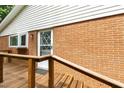 Back porch shows a brick exterior wall and wooden railing at 3517 Morningside Dr, Raleigh, NC 27607