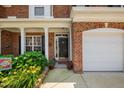 Charming brick home featuring a welcoming front door, well-manicured landscaping, and a two-car garage at 3619 Lion Ridge Ct, Raleigh, NC 27612