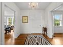 Bright foyer with hardwood floors, a chandelier, and neutral decor, creating a welcoming and elegant entrance at 3816 Dover Rd, Durham, NC 27707