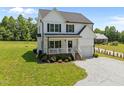 Charming two-story home with a welcoming front porch, gravel drive, and well manicured lawn at 412 Carr Store Rd, Cedar Grove, NC 27231