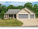 Charming tan home with a large driveway and a two car garage at 50 Viajar Way, Smithfield, NC 27577
