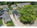 Aerial view of a home with a long driveway, established trees, and a community with well-maintained lawns at 505 Stratton Way, Durham, NC 27704