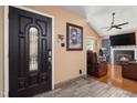 Inviting entryway with decorative front door, wood-look tile flooring, and view into the cozy living room with fireplace at 505 Stratton Way, Durham, NC 27704