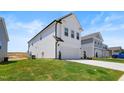 Side view of a two-story home with a lush green lawn and a two car garage at 5113 Ranger Grove Way, Raleigh, NC 27604