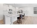 Beautiful kitchen featuring an island with counter seating, stylish countertops, and stainless steel appliances at 5113 Ranger Grove Way, Raleigh, NC 27604