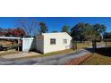 Garage area with a paved driveway and black metal fence at 526 N Fairview Rd, Rocky Mount, NC 27801