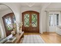 Bright foyer with hardwood floors, a large mirror, and elegant double doors at 5308 Montclair Dr, Raleigh, NC 27609