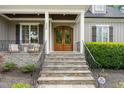 Inviting front entrance with stone steps leading to a custom wood double-door at 5308 Montclair Dr, Raleigh, NC 27609