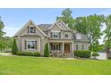 Traditional home showcasing professional landscaping, dormer windows, and a covered front porch at 5308 Montclair Dr, Raleigh, NC 27609