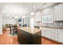 Open-concept kitchen with granite countertops, white cabinetry, stainless steel appliances, and an island at 5412 Emerald Spring Dr, Knightdale, NC 27545