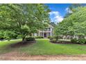 Picturesque home nestled among mature trees with a lush lawn and charming curb appeal creates a serene setting at 5521 Erinvale Ct, Holly Springs, NC 27540