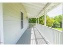 Covered front porch featuring classic railing and ceiling fans creating an ideal outdoor space at 5625 Church Rd, Graham, NC 27253
