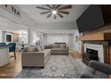 Comfortable living room with fireplace, wooden beams, a fan, and neutral-toned furniture at 6447 Beulah Church Rd, Liberty, NC 27298