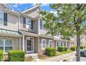 Attractive townhome showcasing stone and siding accents with lush greenery at 711 Keystone Park Dr # 7, Morrisville, NC 27560
