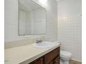 Clean bathroom with white tile, classic fixtures, and a vanity with storage at 713 Marlboro Pl, Rocky Mount, NC 27801